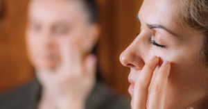 Woman using EFT tapping yoga teacher training to reduce stress