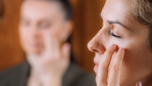 Woman using EFT tapping yoga teacher training to reduce stress
