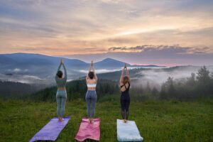 Woman practicing yoga outdoors at sunrise after successful weight loss, focusing on strength, healthy aging, longevity, and sustainable wellness beyond GLP-1 medications.